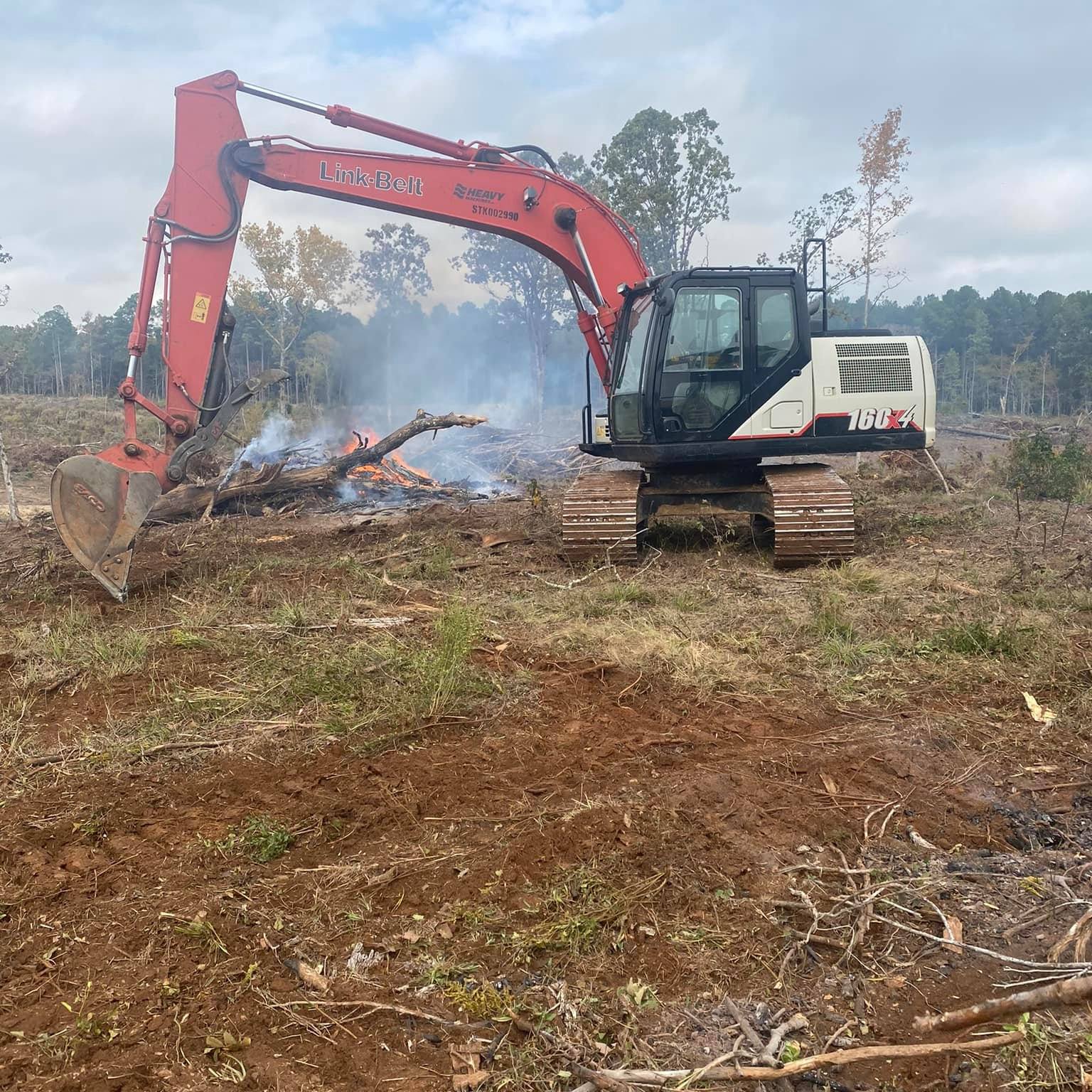 Bulldozer clearing land at sunset in East Texas